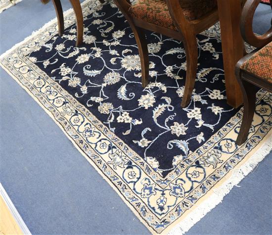 A Nain dark blue ground rug 190 x 115cm